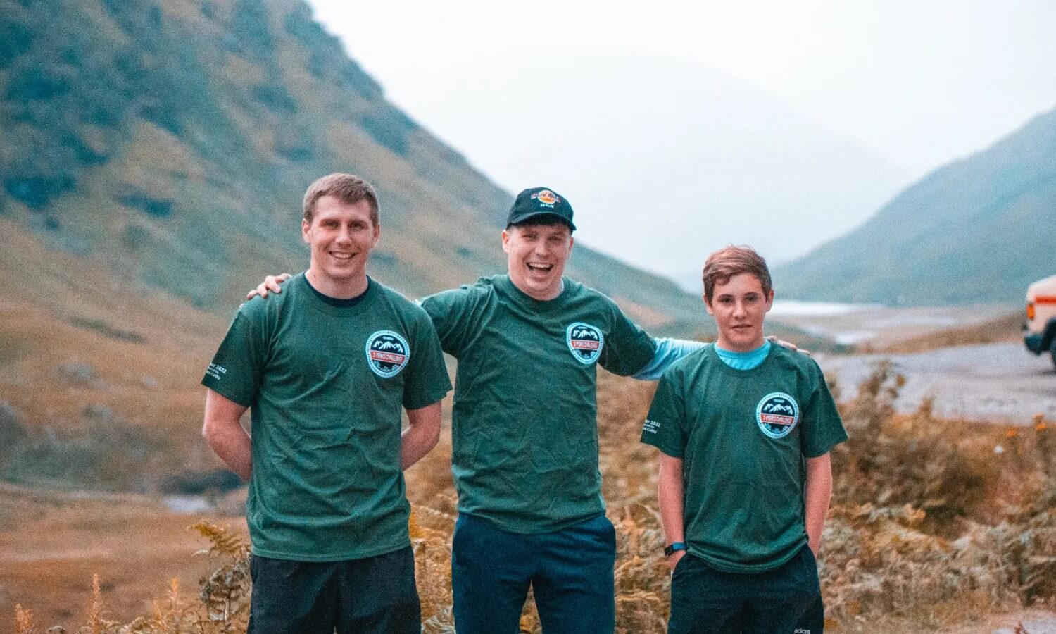 Three men wearing matching t-shirts